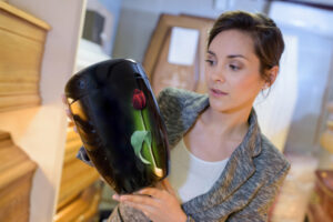 Woman selecting an urn in a funeral home