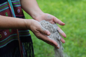 Close up of woman's hands spreading ashes